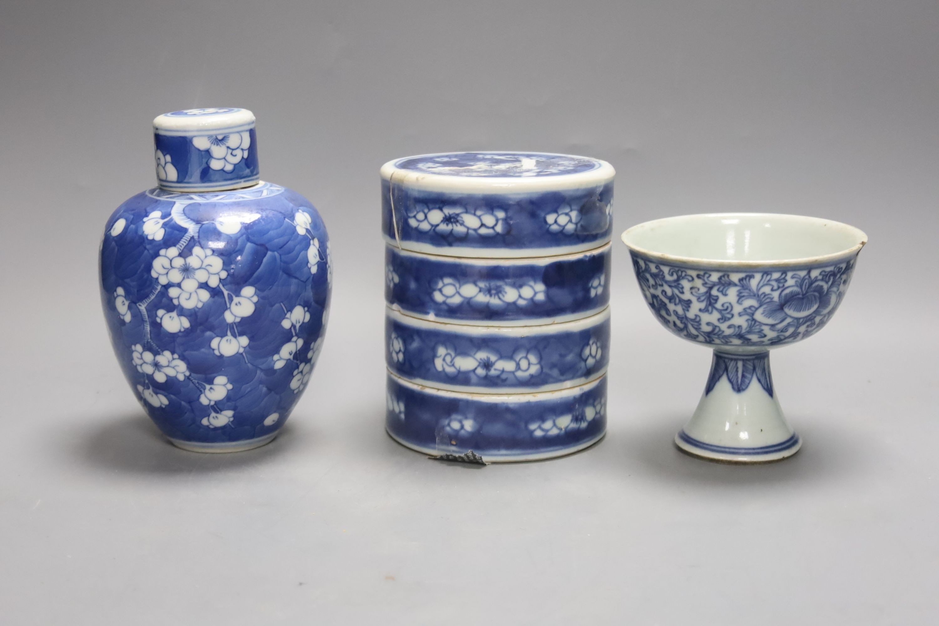 A Chinese blue and white ovoid jar and cover and similar stacking box, Kangxi and a Qing blue and white footed cup, tallest 15cm